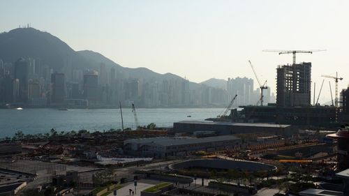 High angle view of buildings by sea against sky