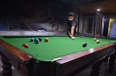 Man playing with ball on table