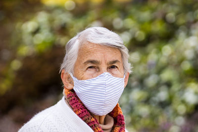 Portrait of woman covering face outdoors