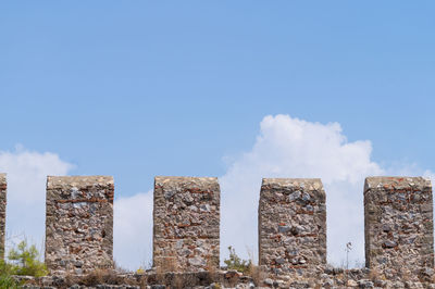 Low angle view of alanya castle stone wall against sky