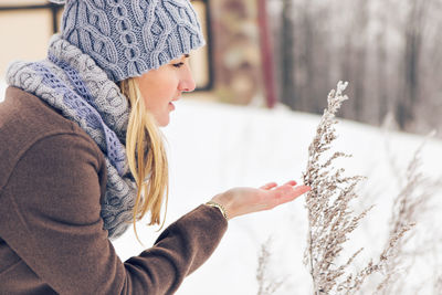 Side view of girl looking at snow