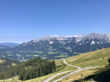 Scenic view of mountains against clear blue sky