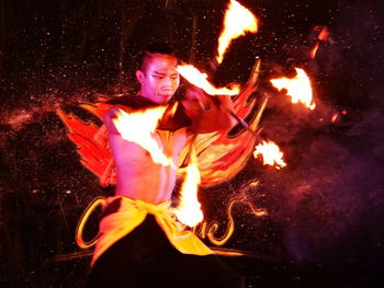 Young woman with fire crackers at night