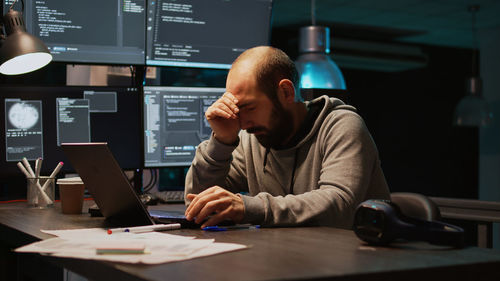 Young man using laptop at table