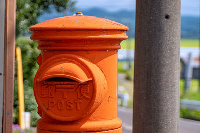 Close-up of text on metal pole