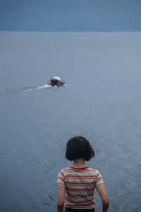 Rear view of boy looking at sea