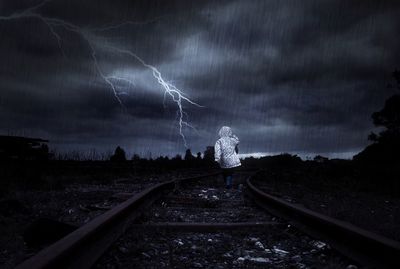 View of railroad tracks against cloudy sky