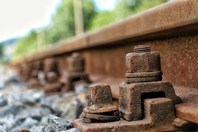 Close-up of rusty old nuts on railroad tracks