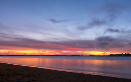 Scenic view of lake against romantic sky at sunset