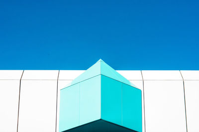 Low angle view of modern building against clear blue sky