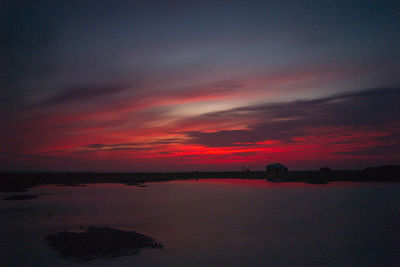 Scenic view of sea against romantic sky at sunset