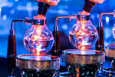 Close-up of wine bottles against blue glass