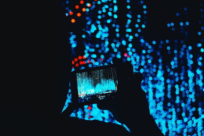 Defocused image of illuminated lights in darkroom