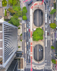 Traffic on road amidst buildings in city - paulista avenue