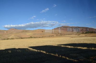 Scenic view of landscape against blue sky