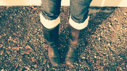 Low section of women boots standing outdoors