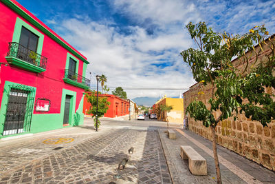 Street amidst buildings against sky in city