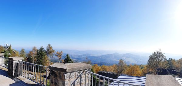 Scenic view of mountains against clear blue sky