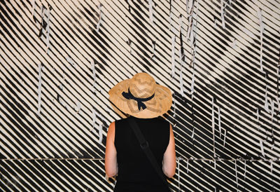 Woman standing in front of striped wall