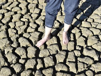 Low section of person standing on cobblestone