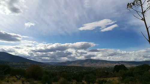 Scenic view of mountains against blue sky