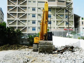 View of dump truck on construction site by building