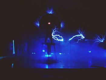 Low angle view of illuminated ferris wheel at night
