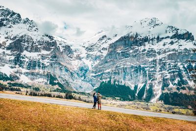 Couple looking at snowcapped mountain