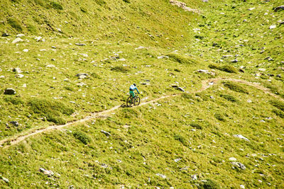 High angle view of woman riding bicycle on land