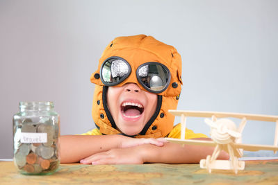 Portrait of young woman wearing sunglasses while sitting on table