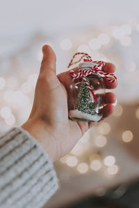 Close-up of hand holding christmas decoration