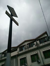 Low angle view of building against cloudy sky