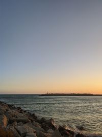 Scenic view of sea against clear sky during sunset