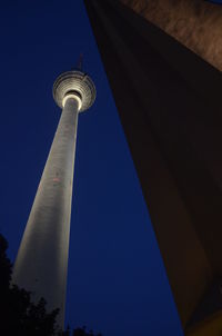 Low angle view of communications tower against sky