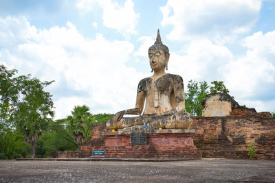 Statue of temple against cloudy sky