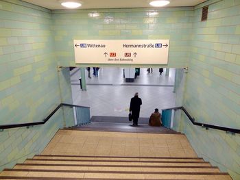 Rear view of a man walking in corridor