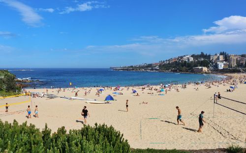 People on beach against sky