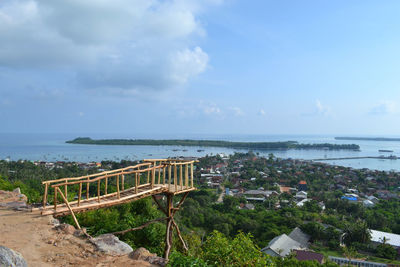 Scenic view of sea by buildings against sky