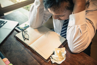 High angle view of man working on table