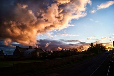 View of road against cloudy sky at night