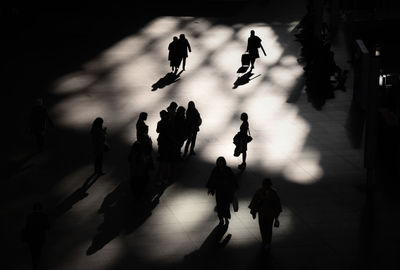 High angle view of silhouette people walking in city