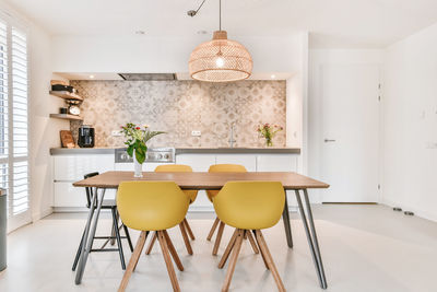 Empty chairs and table against wall at home