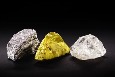 Close-up of multi colored rocks against black background