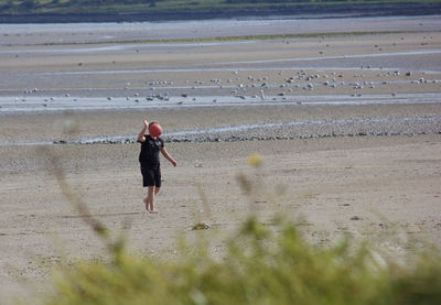 Full length of man walking on beach