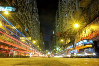 Illuminated city against sky at night