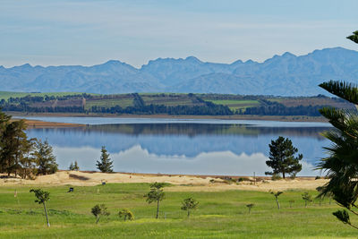 Scenic view of lake and mountains against sky