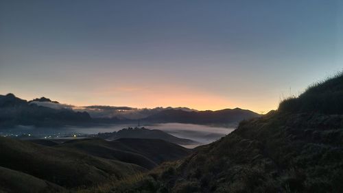 Scenic view of mountains against clear sky during sunset