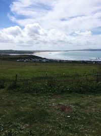 Scenic view of calm sea against cloudy sky