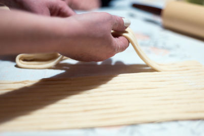 Close-up of person preparing food on table