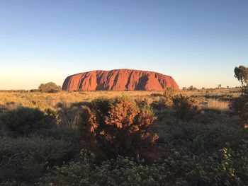 Rock formations on landscape against clear sky